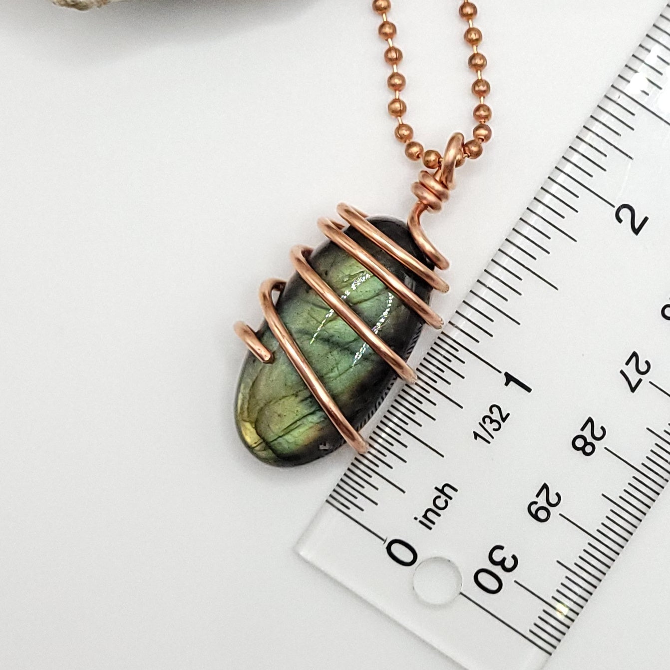 labradorite necklace in copper next to ruler