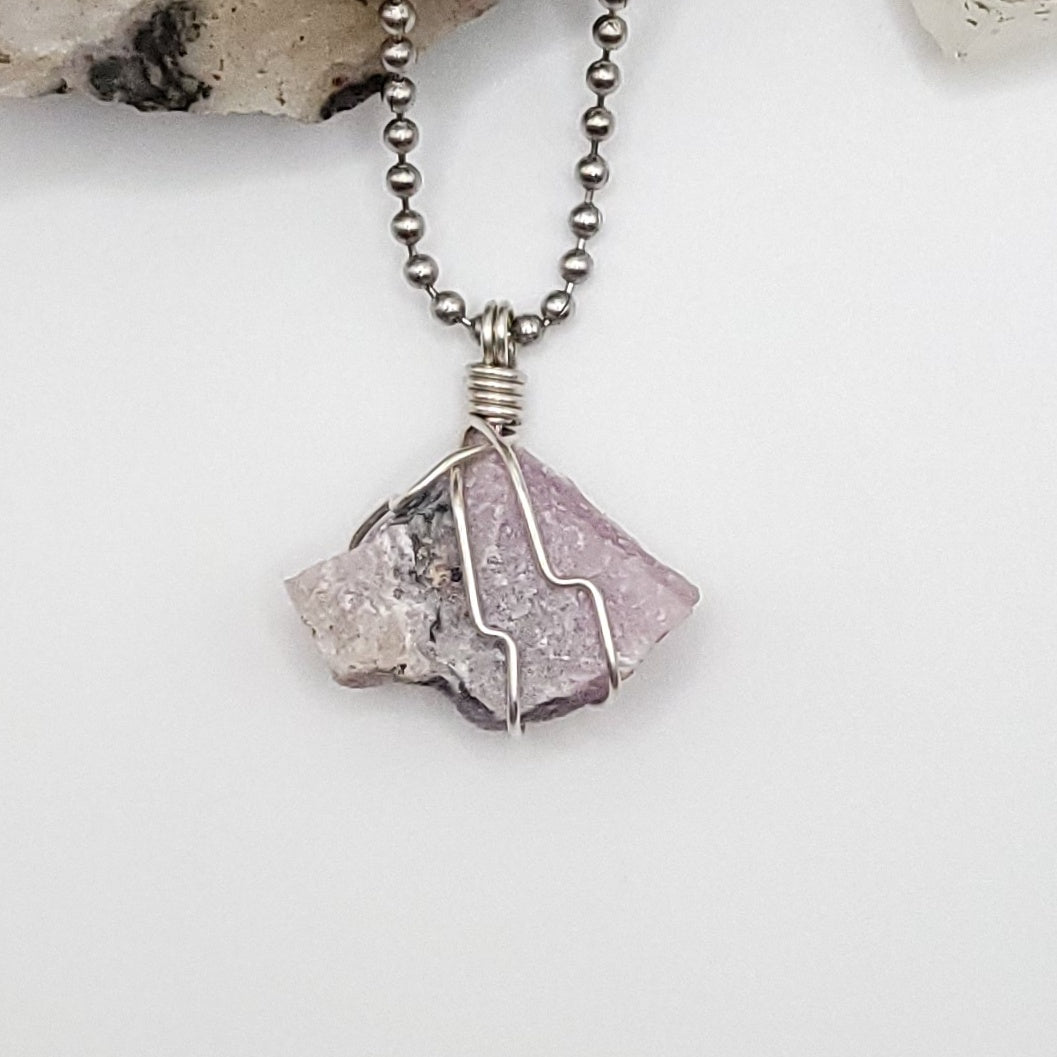 raw pink moonstone necklace in silver wire on white background