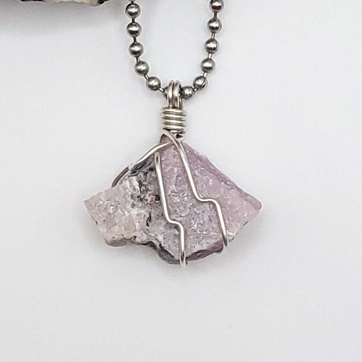raw pink moonstone necklace in silver up close