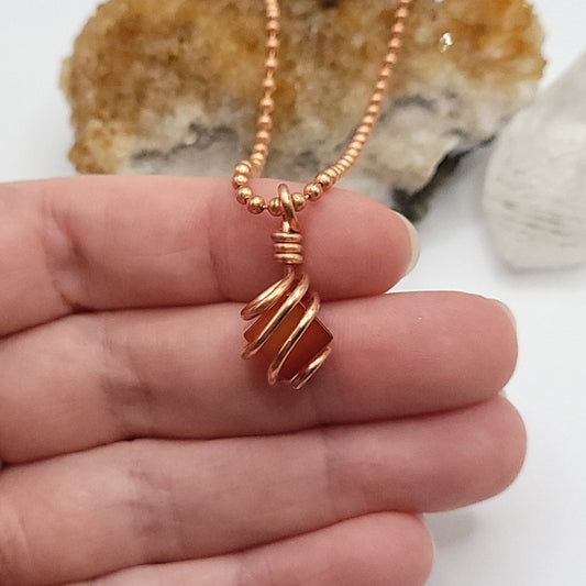 carnelian necklace in copper wire in hand