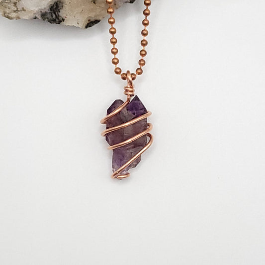 raw amethyst necklace in copper on white background