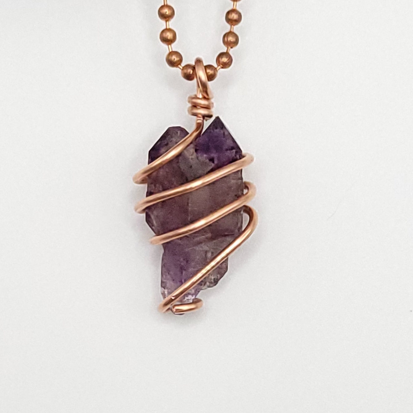 raw amethyst necklace in copper close up