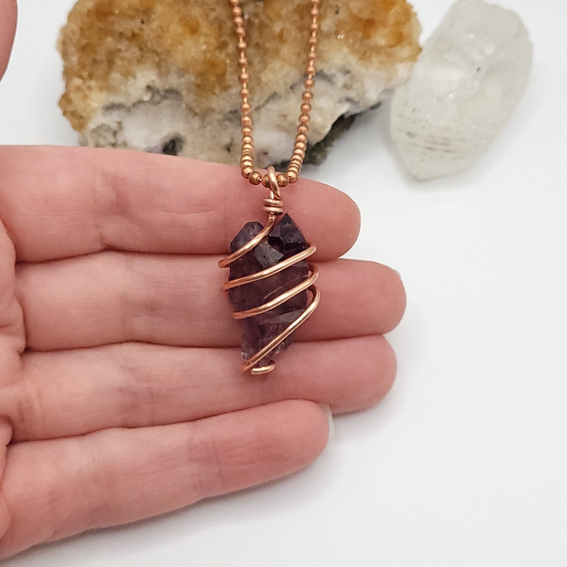 raw amethyst necklace in copper in hand