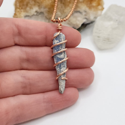 blue kyanite necklace in copper in hand