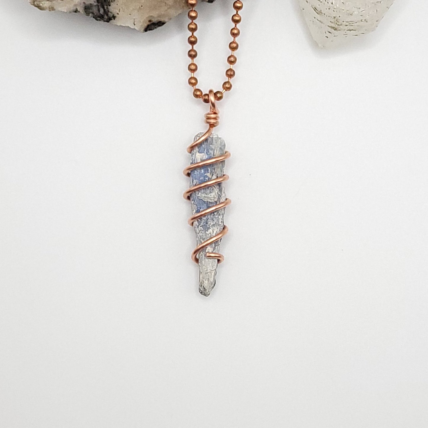 blue kyanite necklace in copper on white background