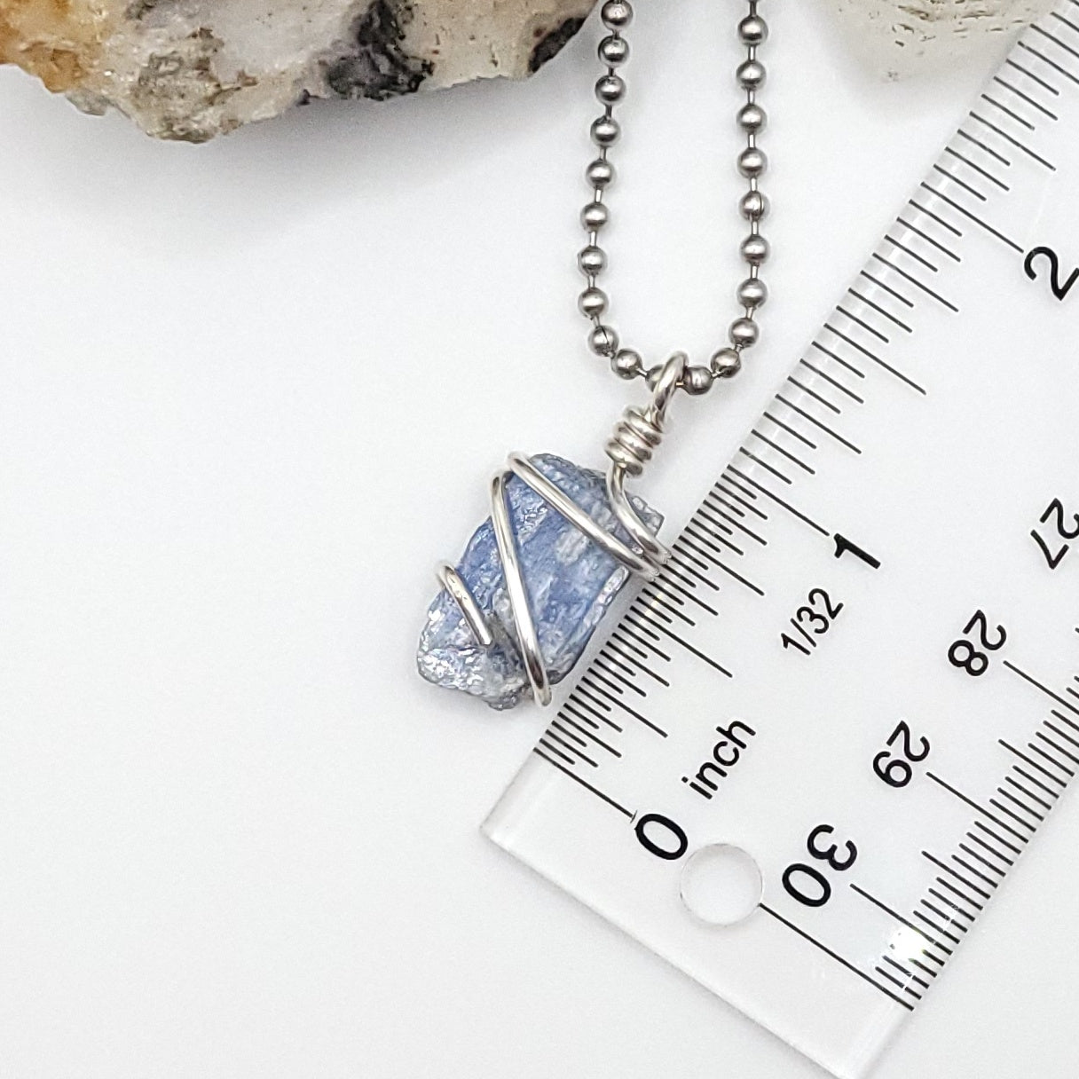 raw blue kyanite necklace in silver wire measurement against ruler