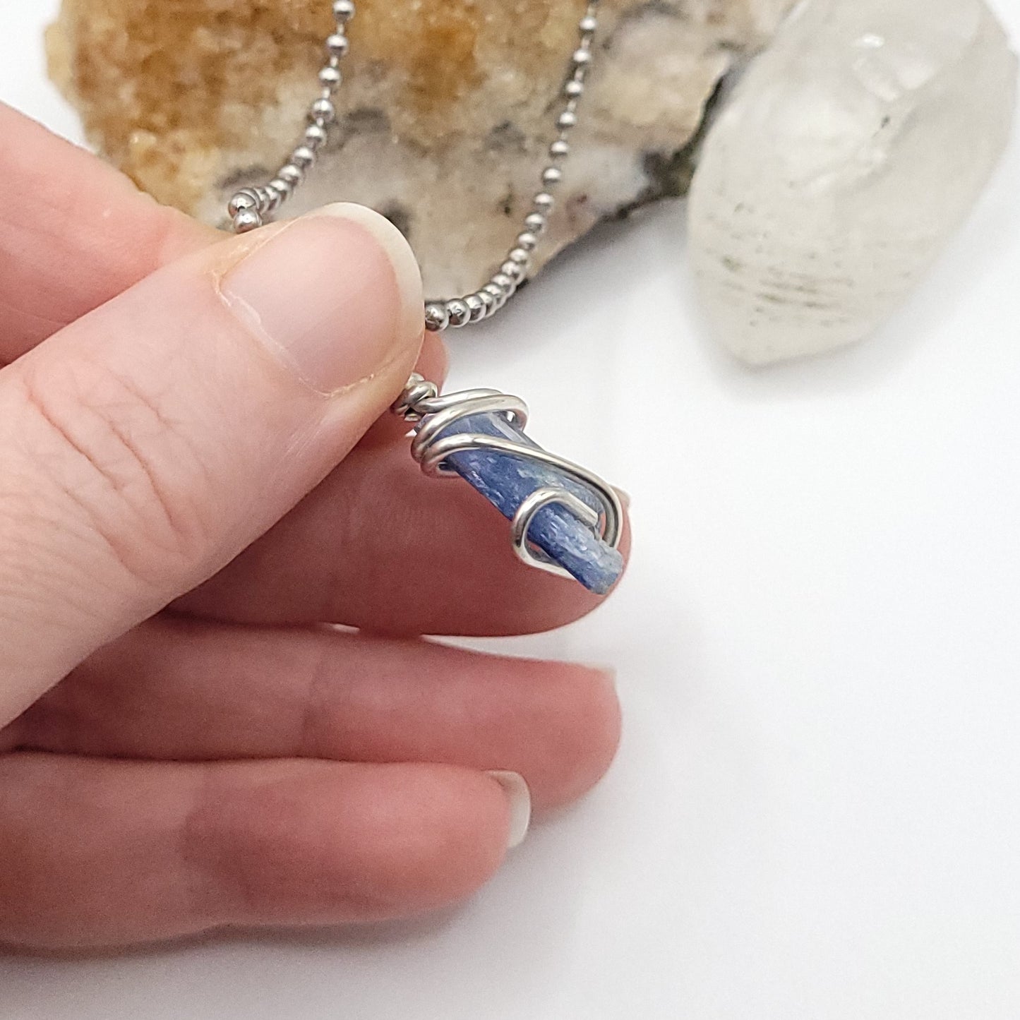 raw blue kyanite necklace in silver wire side view