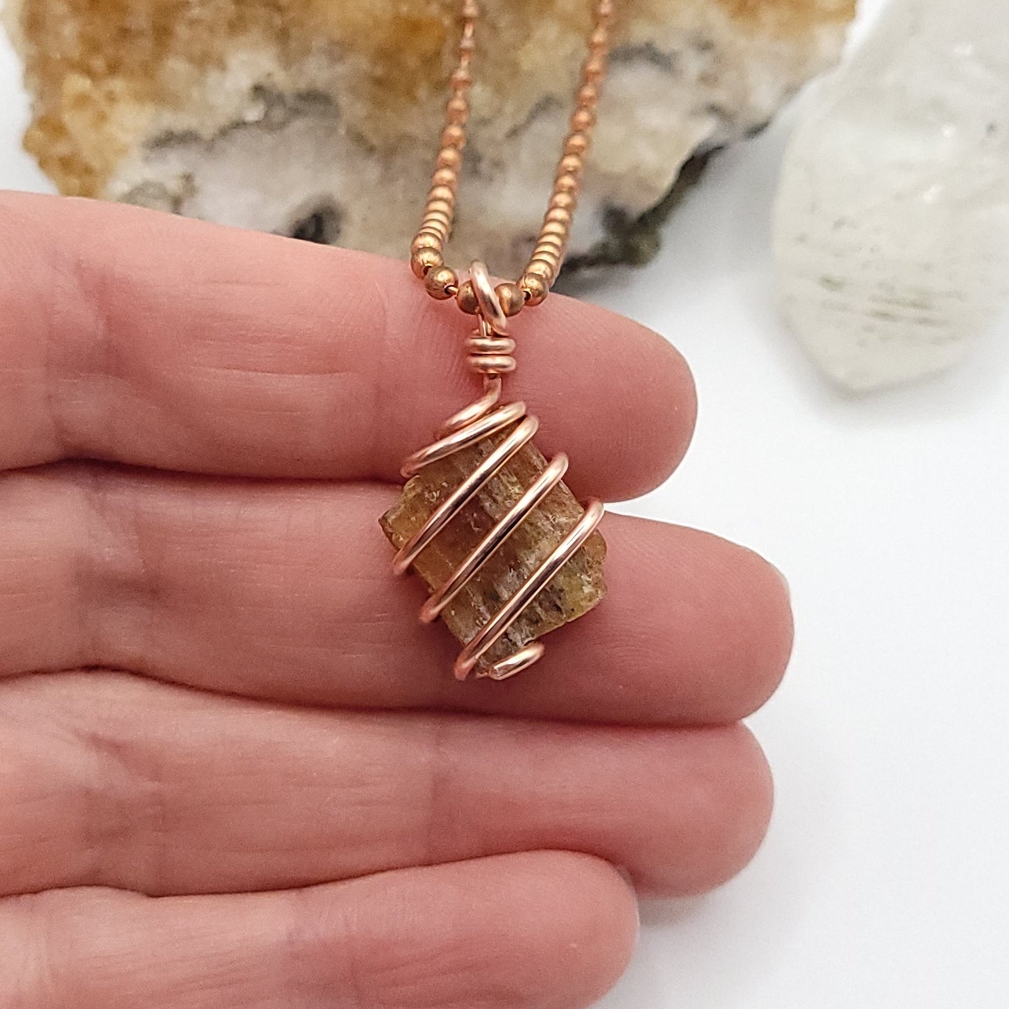 Raw Orange Kyanite Crystal Necklace in Copper, in hand