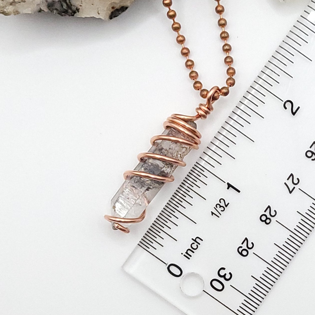 tibetan quartz necklace measurement against ruler