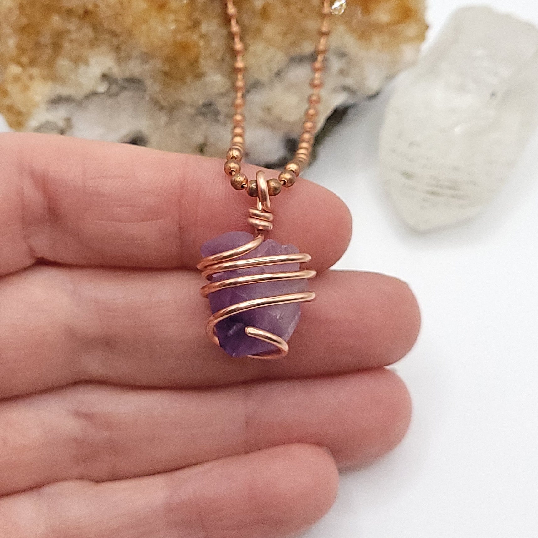 Raw Amethyst Crystal Necklace in Copper, in hand