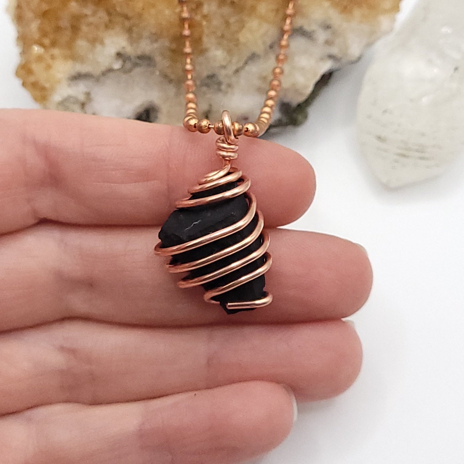 Raw Shungite Crystal Necklace in Copper, in hand
