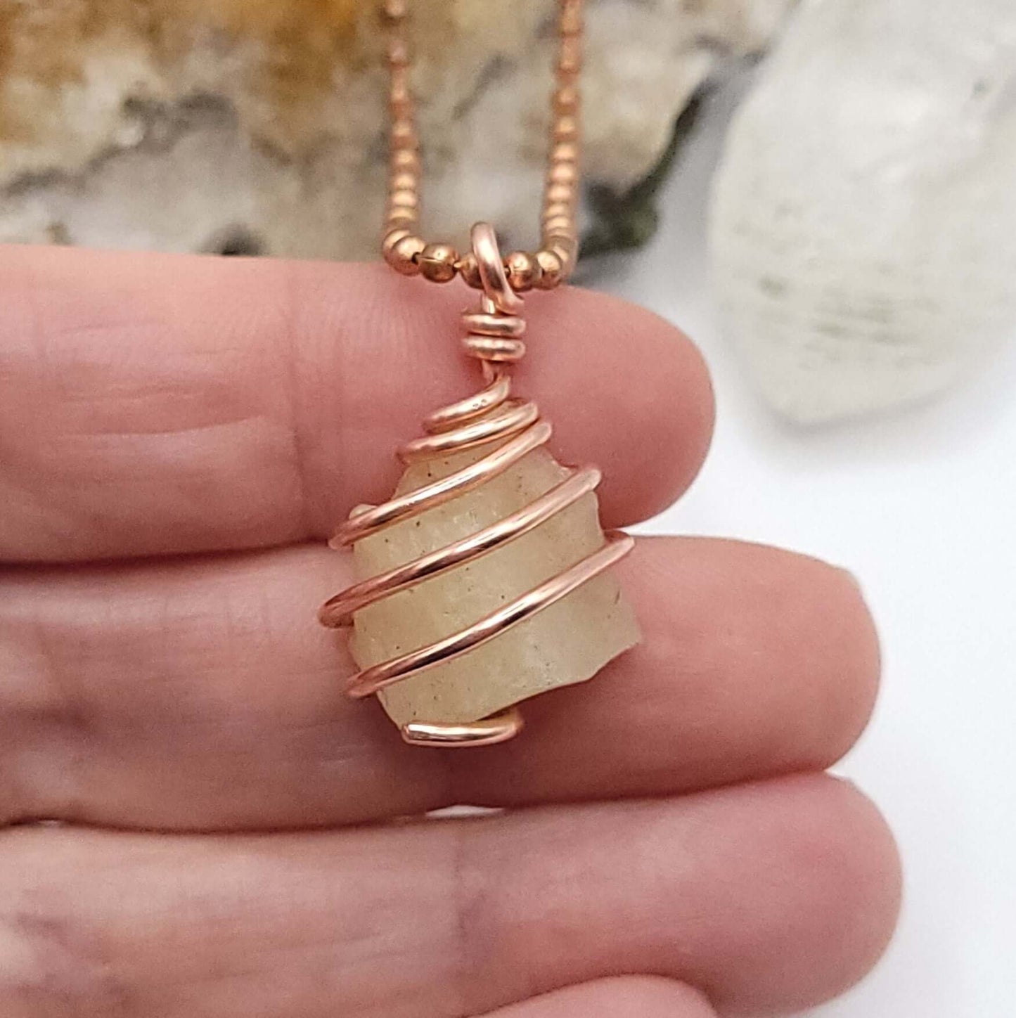 Raw Libyan Desert Glass Necklace in Copper - Close up in hand