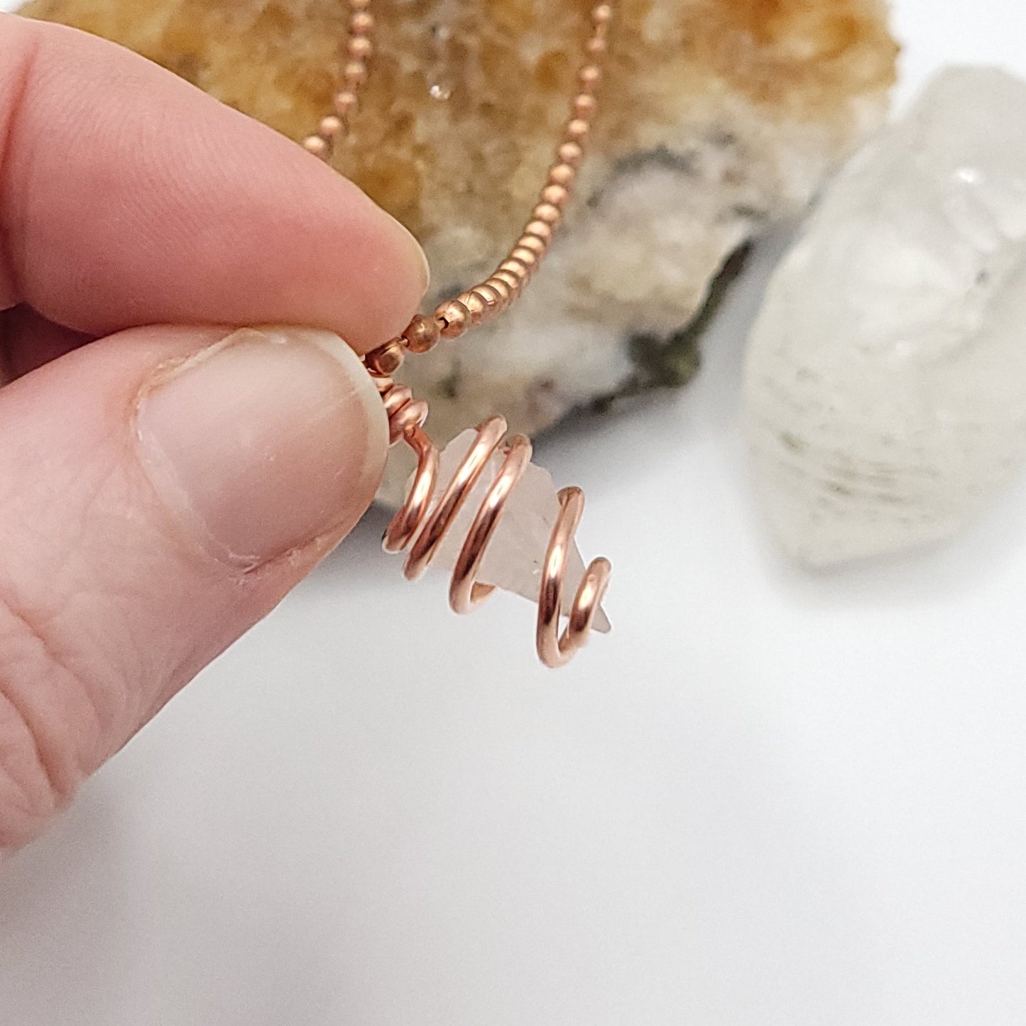 Raw Phenakite Crystal Necklace in Copper, against light