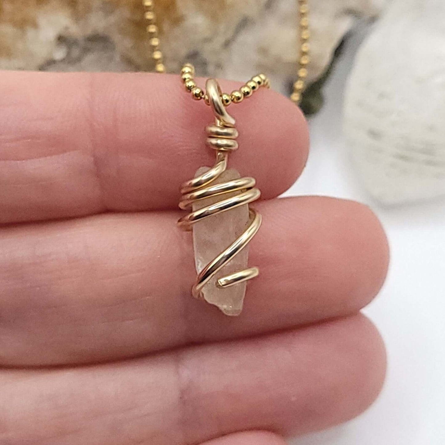 Raw Phenakite Necklace in Gold, close up in hand