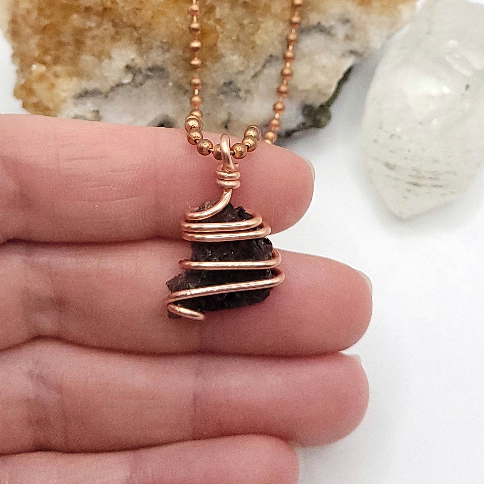 Raw Axinite Crystal Necklace in Copper, in hand