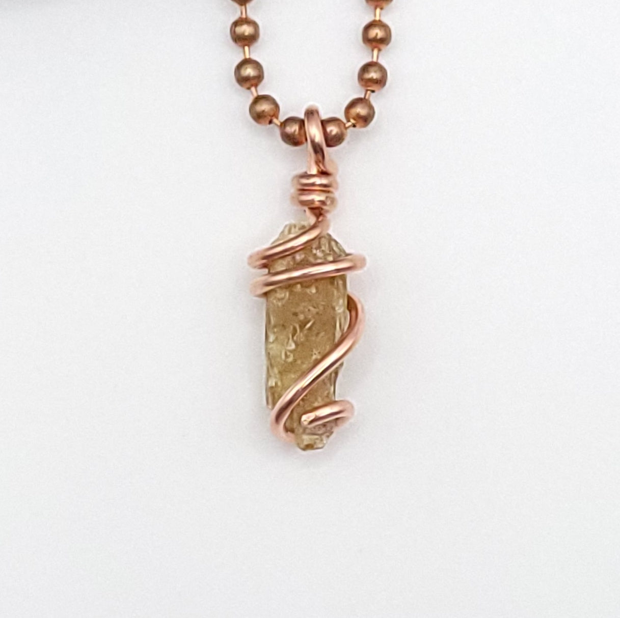 raw yellow kyanite necklace in copper up close