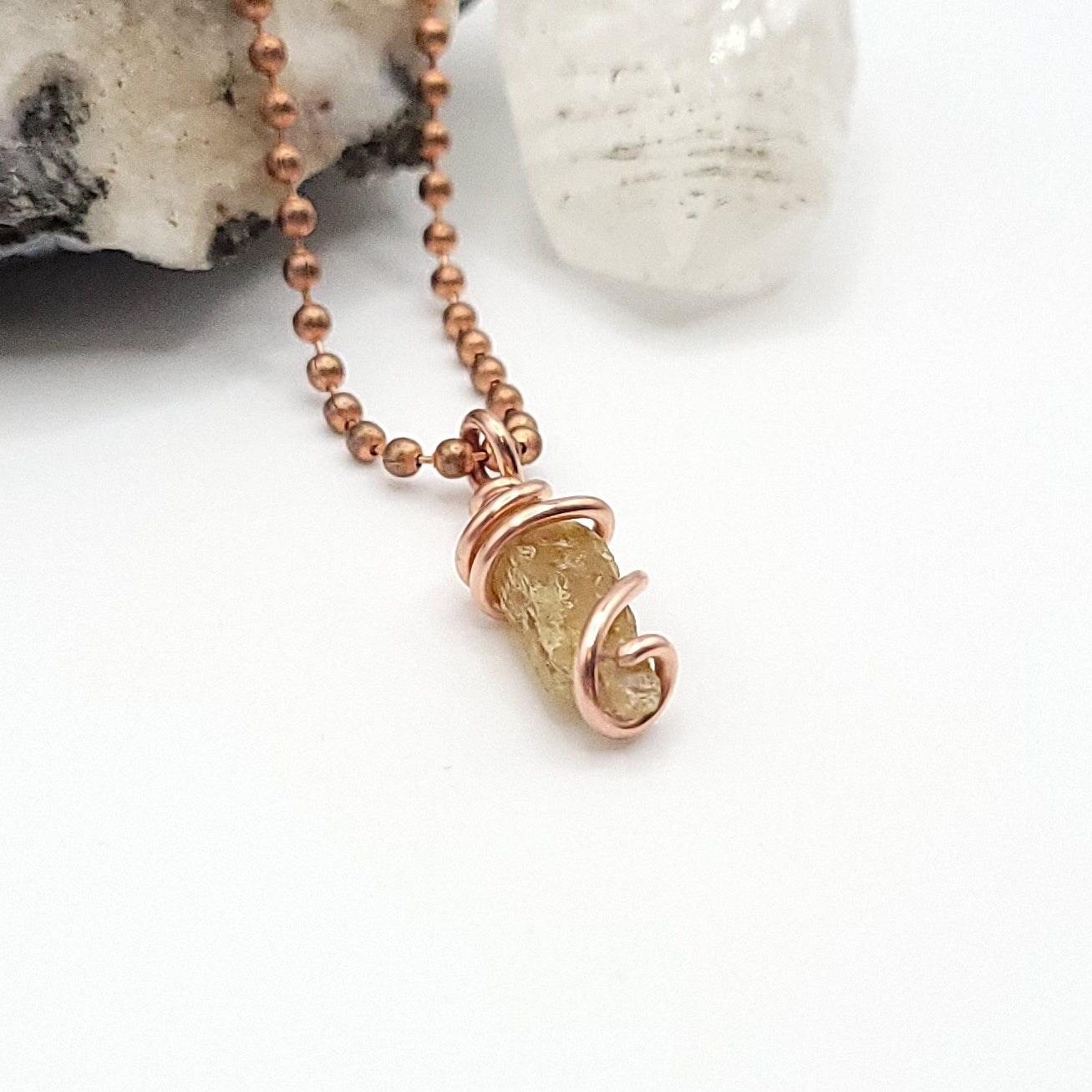 raw yellow kyanite necklace side view on white background