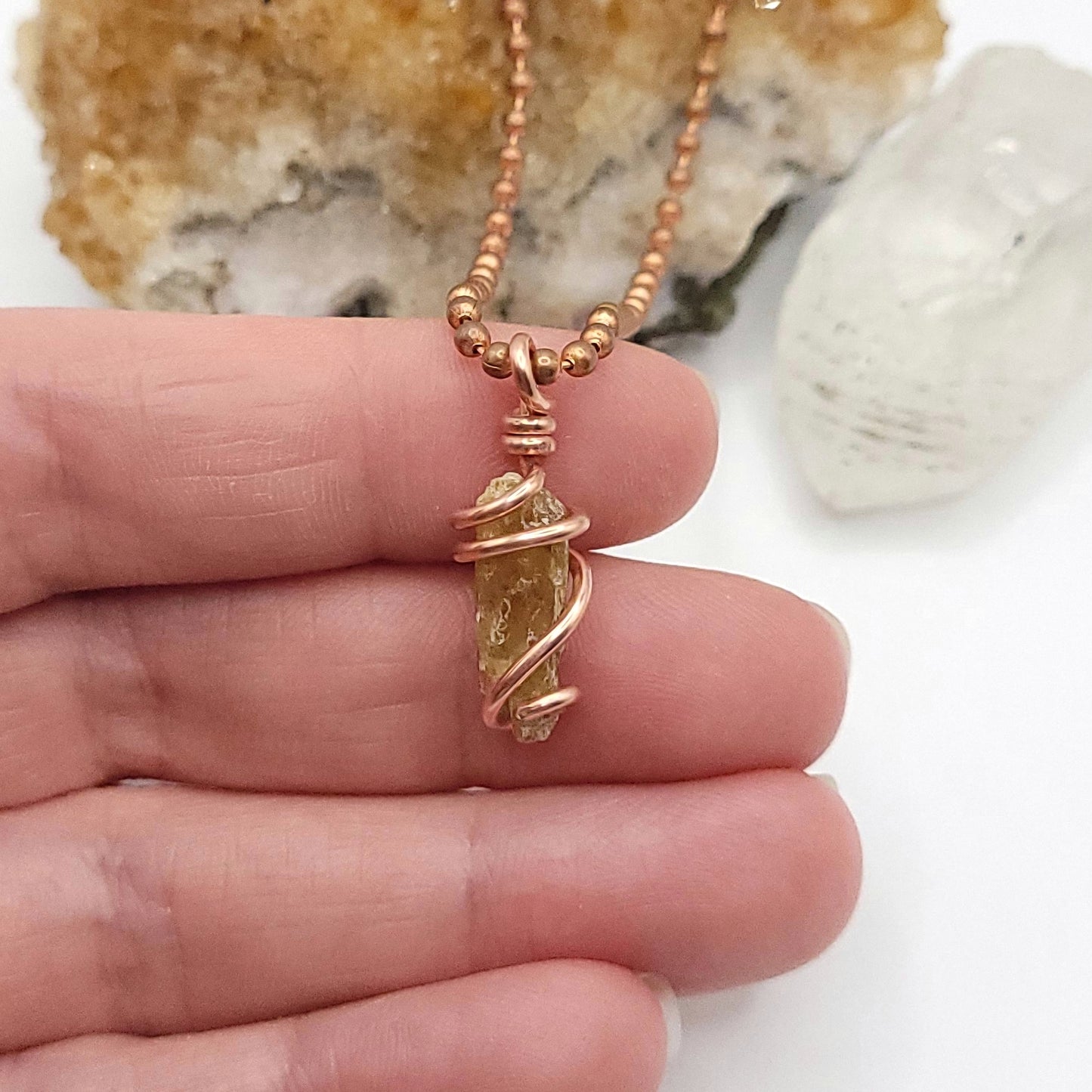 raw yellow kyanite necklace in copper in hand