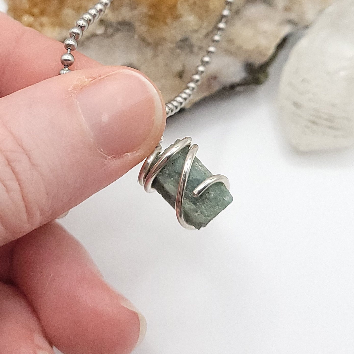 Raw Aquamarine Crystal Necklace in Silver, against light