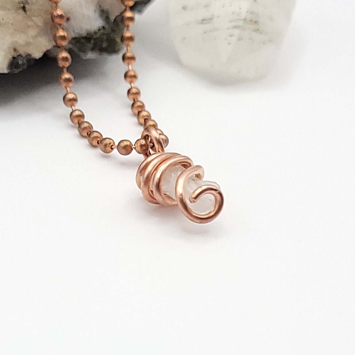phenakite pendant in copper wire side view