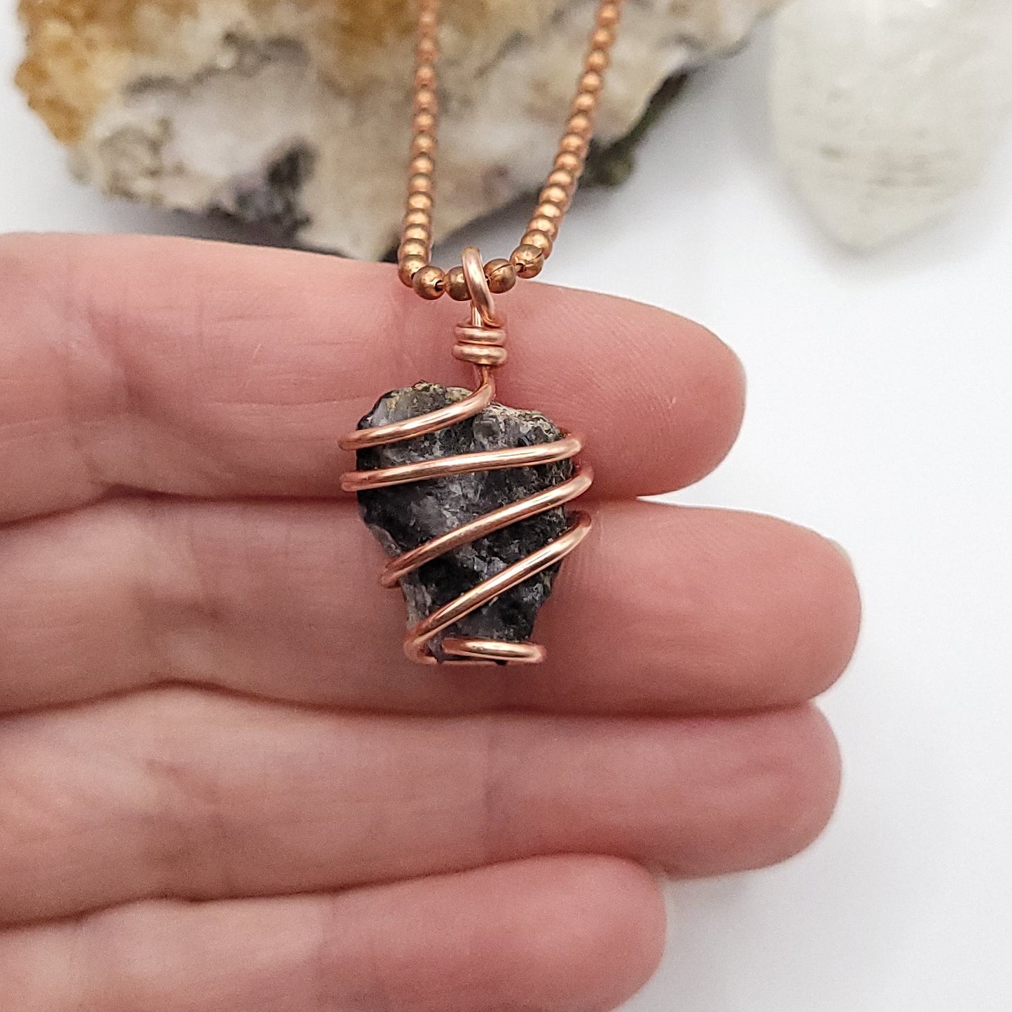 Raw Mystic Merlinite Crystal Necklace in Copper, in hand
