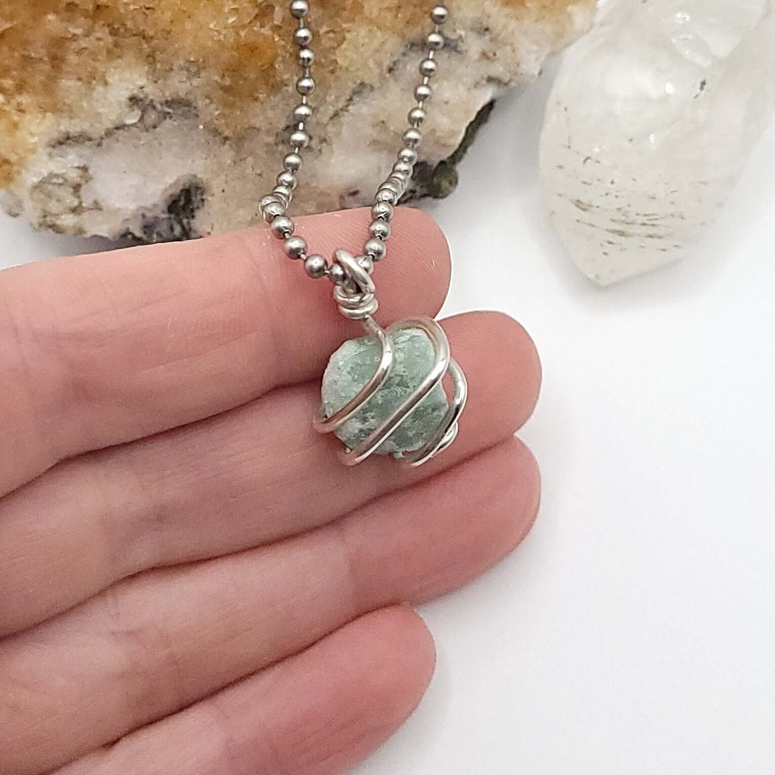 Raw Green Aventurine Crystal Necklace in Silver, side view in hand
