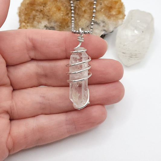 clear quartz necklace in silver in hand