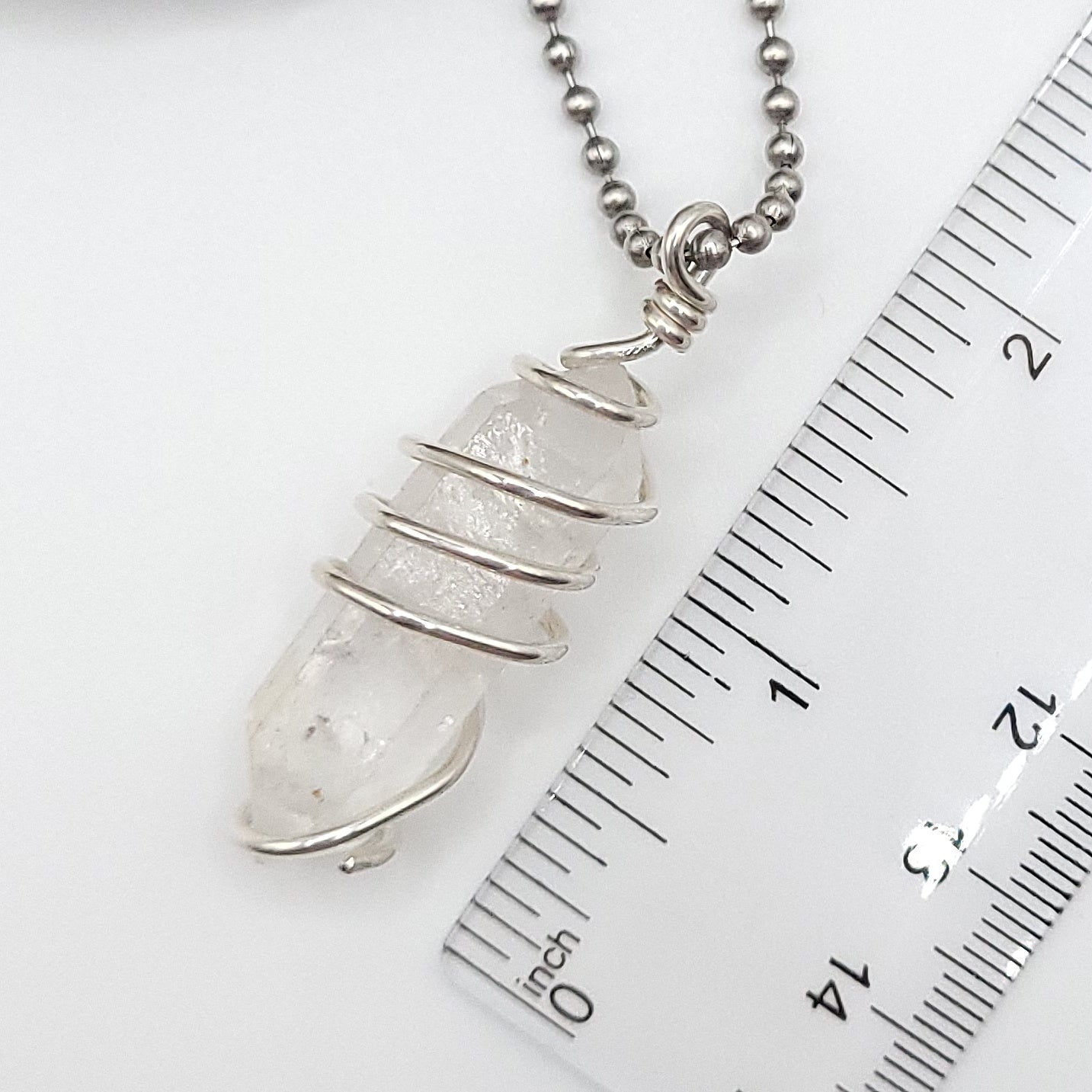 clear quartz necklace in silver measurement against ruler