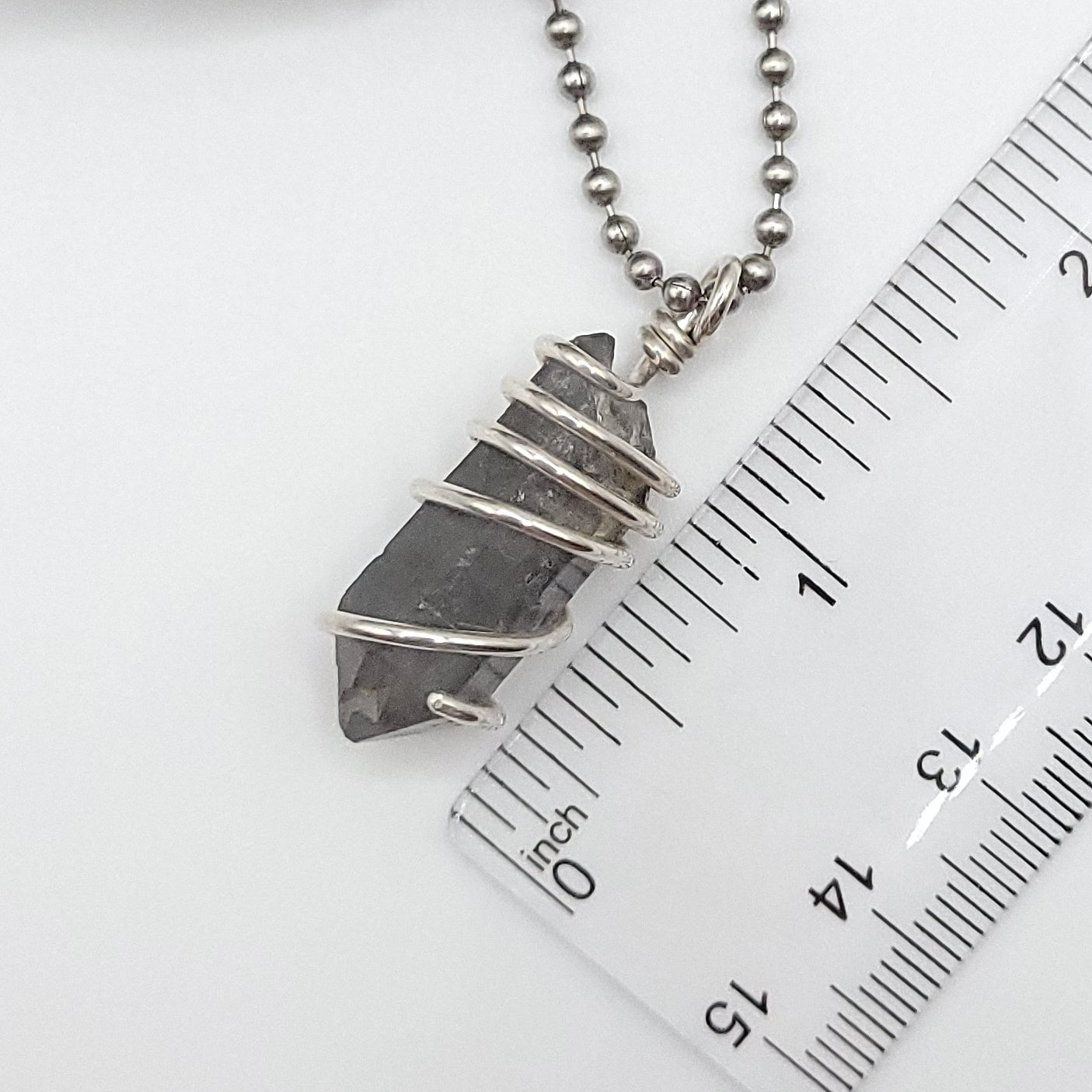 tibetan quartz necklace measurement against ruler