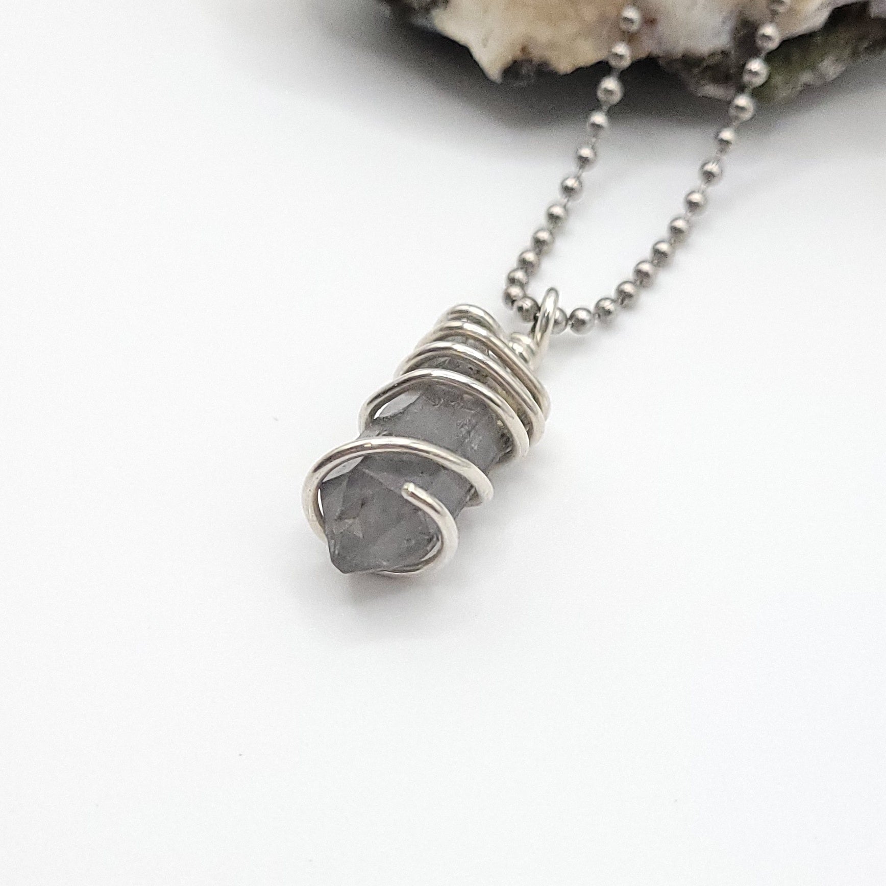 Tibetan Quartz Necklace in Silver showcasing raw stone wrapped in sterling silver for spiritual clarity.