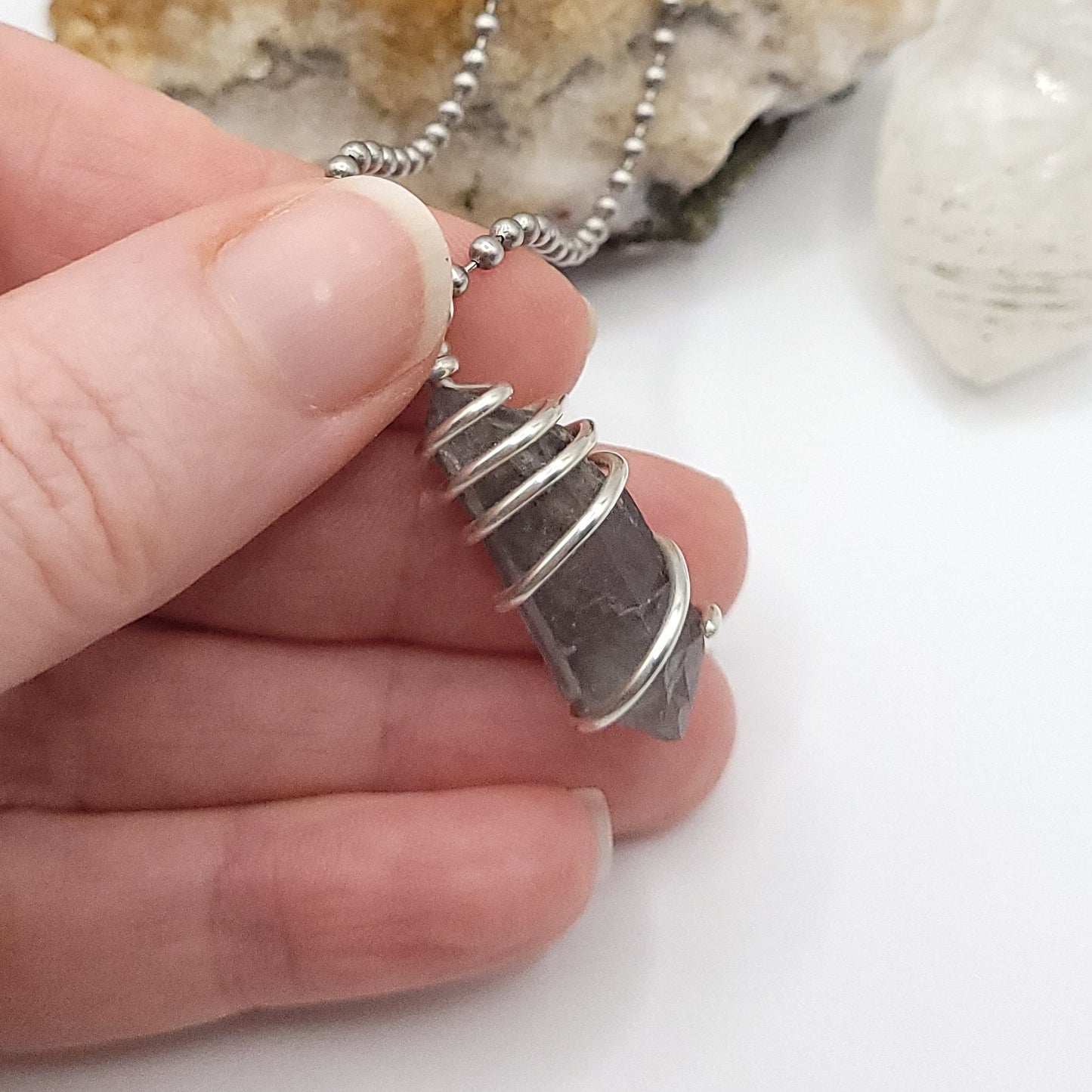 tibetan quartz necklace held in hand