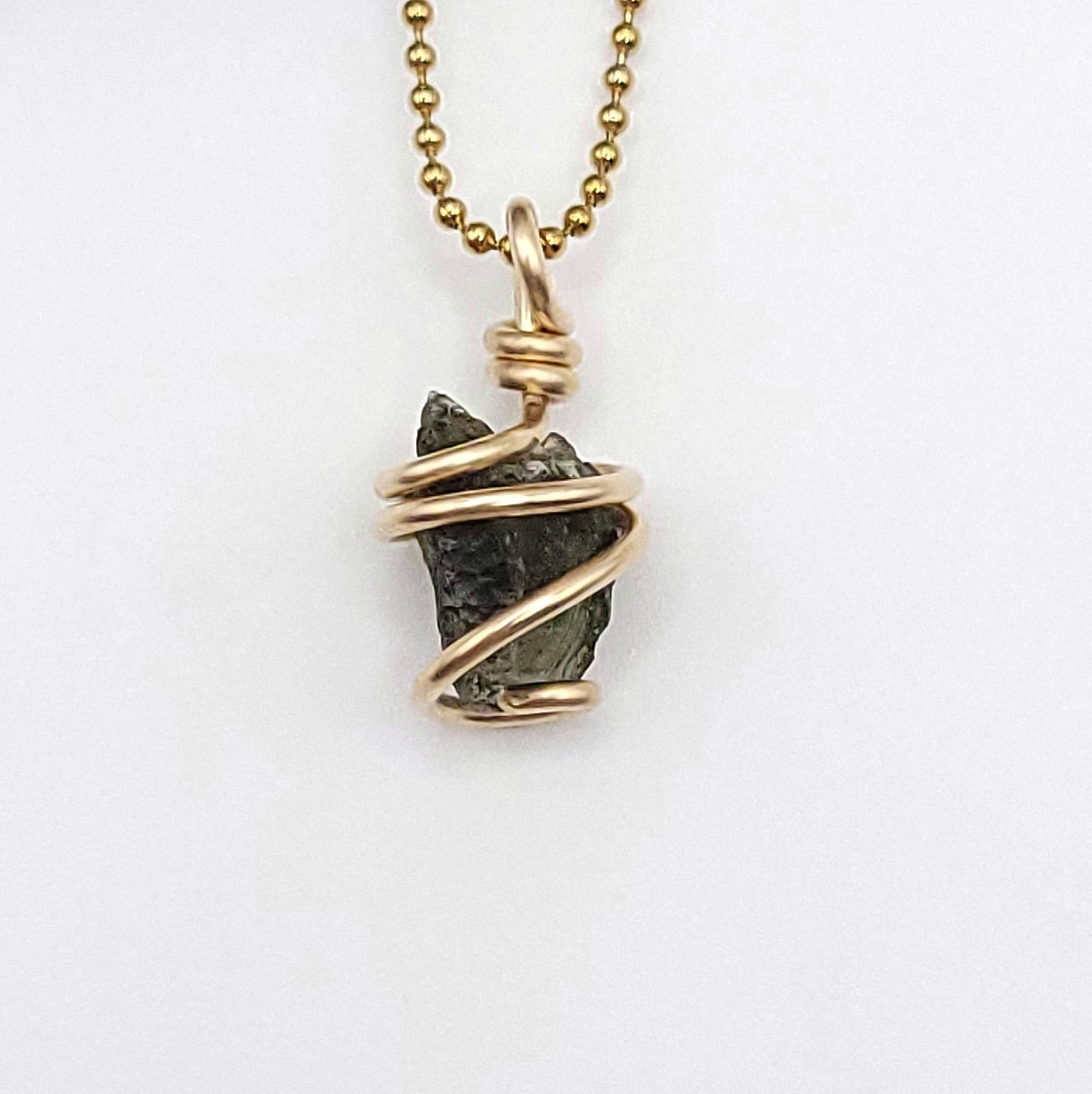 Raw Moldavite Necklace in Gold close up against white background
