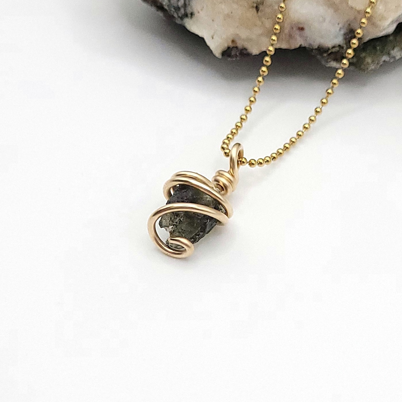 Raw Moldavite Necklace in Gold side view on white background