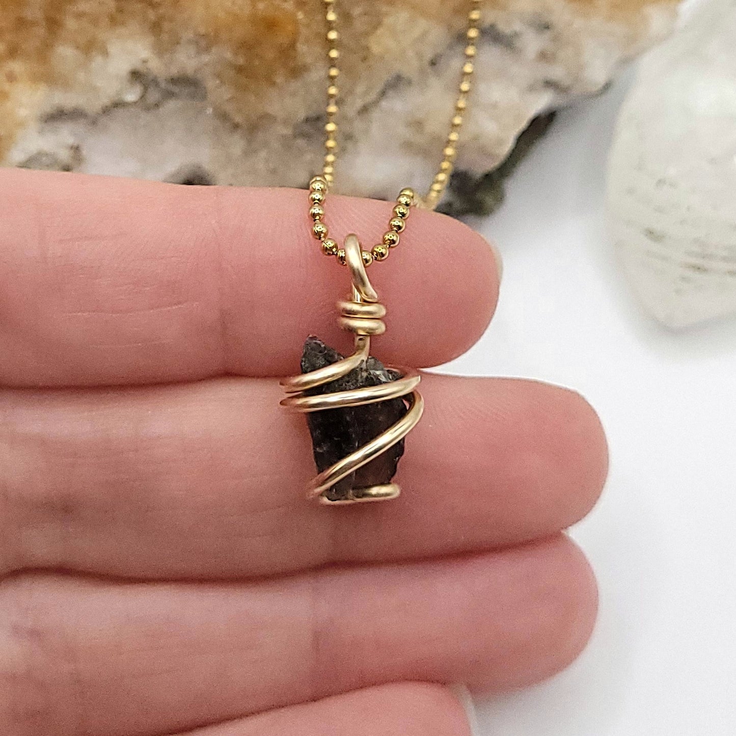 Raw Moldavite Necklace in Gold in hand