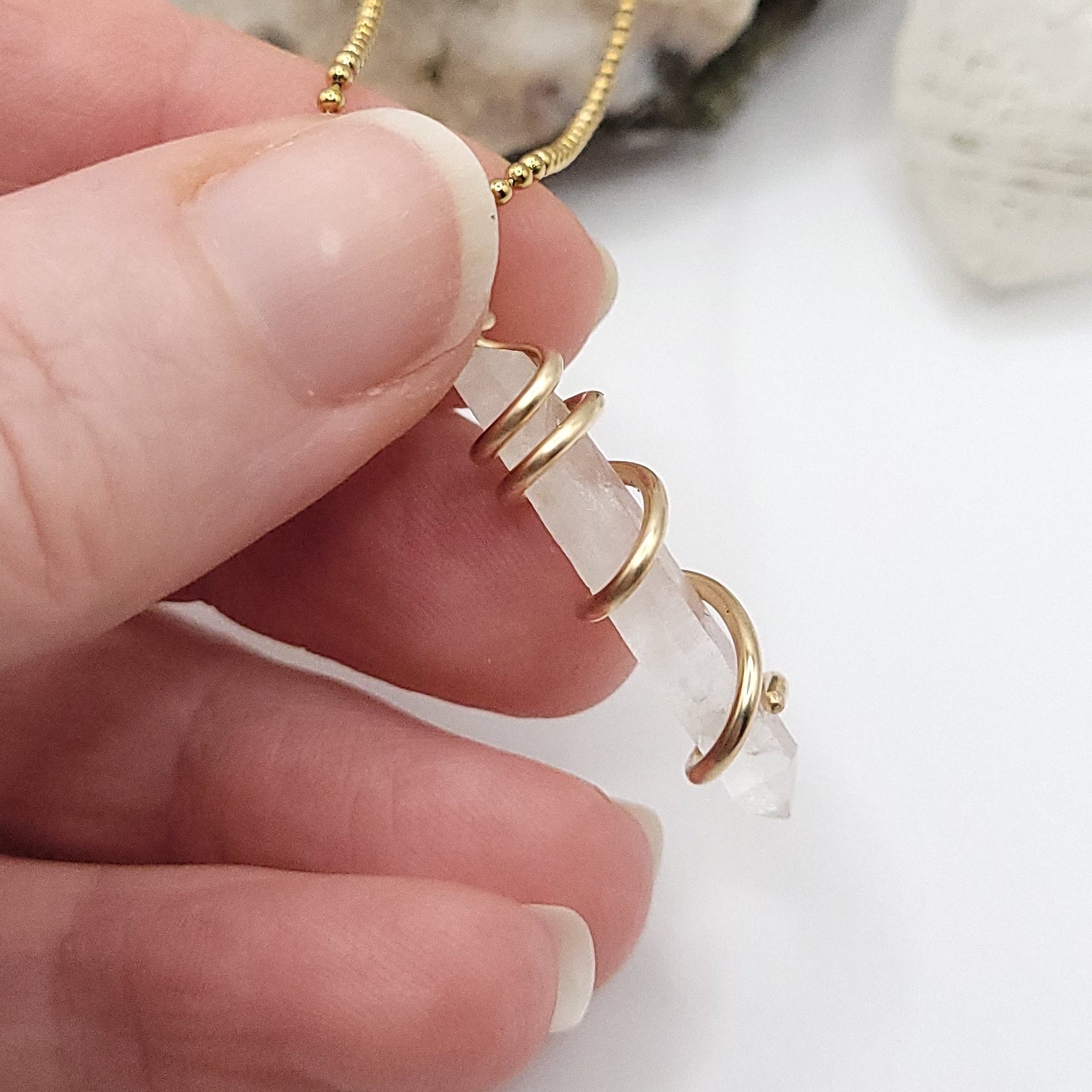 clear quartz necklace in gold up close