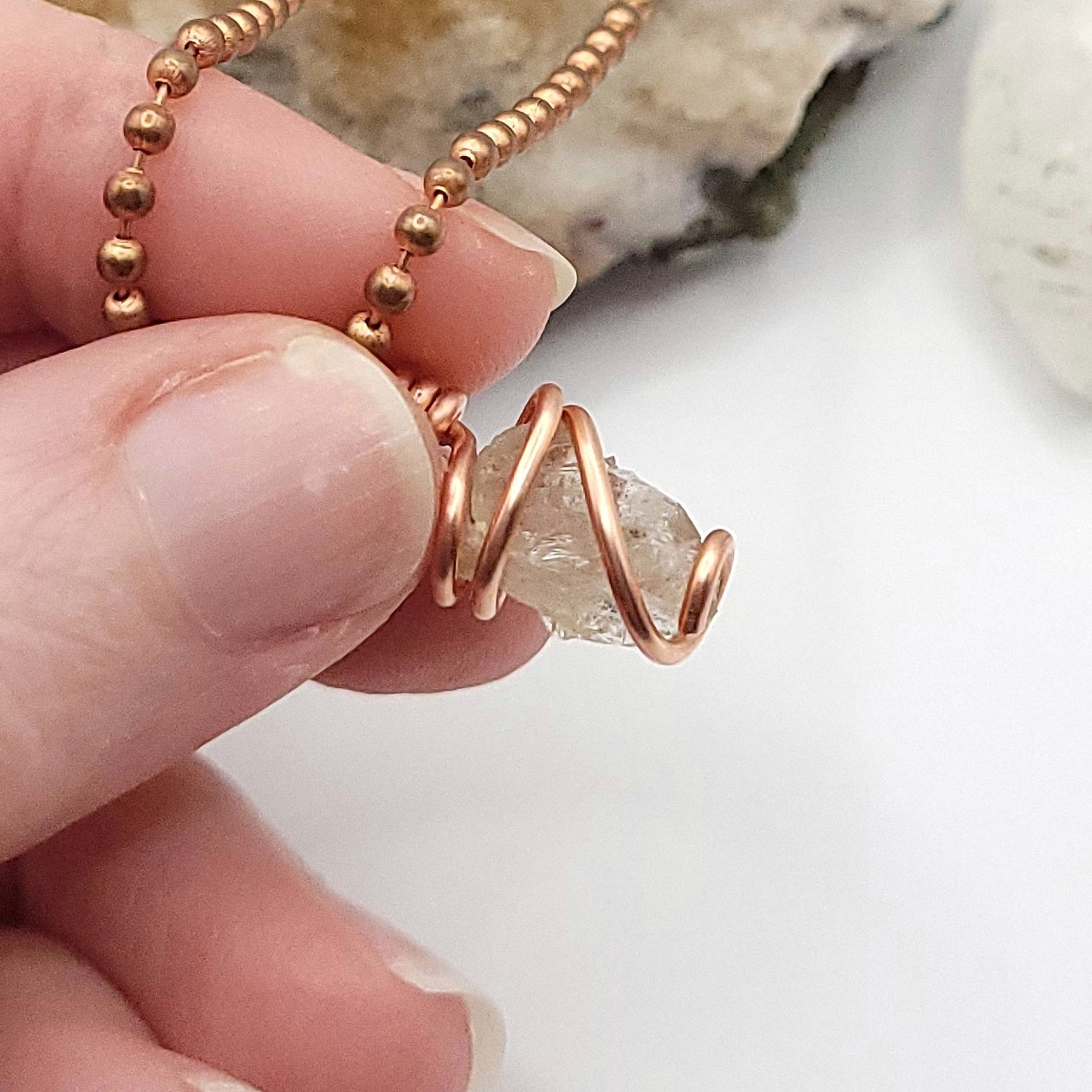 raw citrine pendant side view in hand