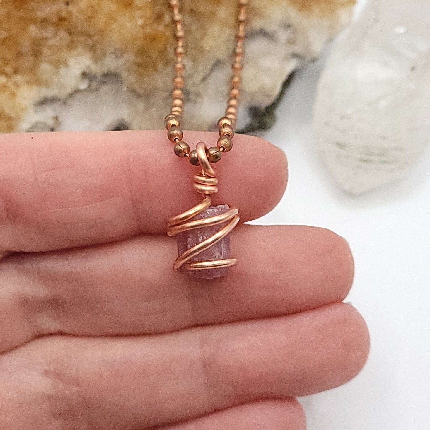 Raw Pink Tourmaline Crystal Necklace in Copper in hand