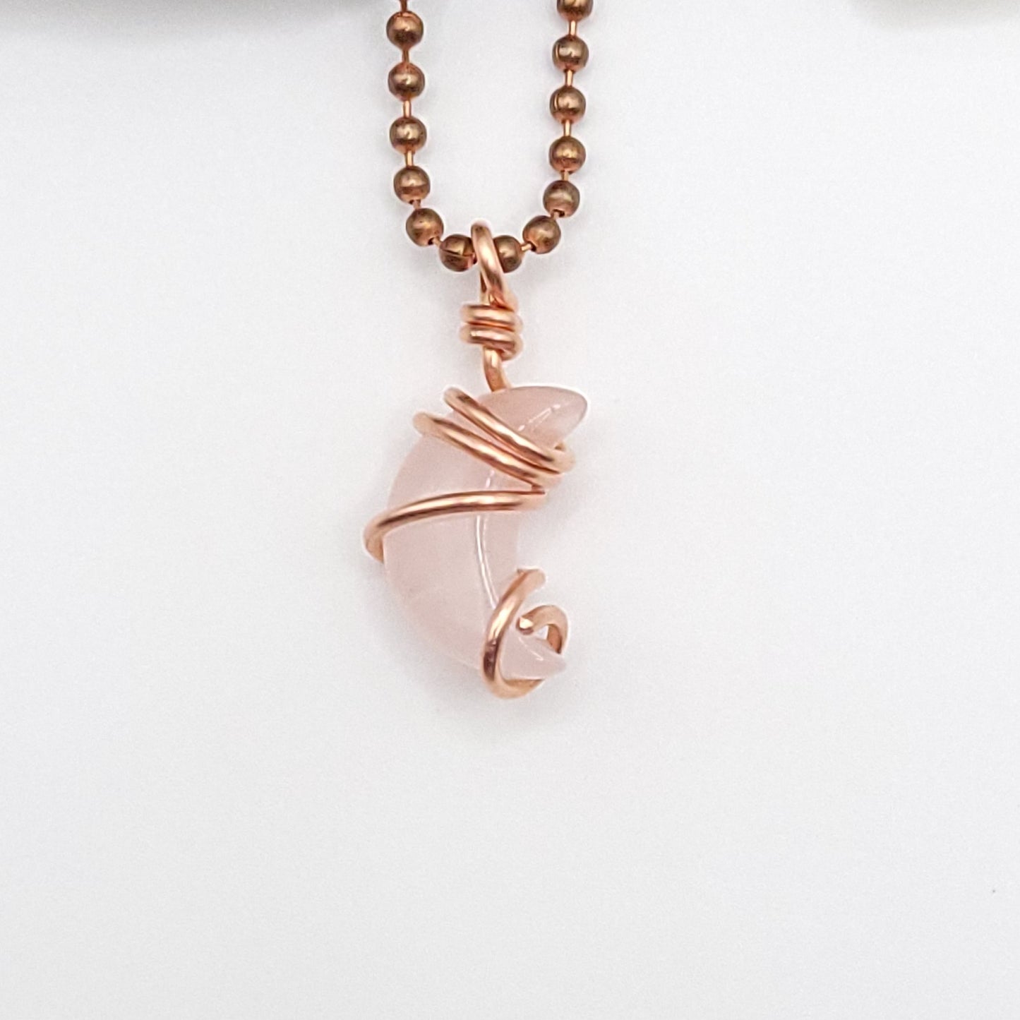 Rose quartz Crescent Moon crystal necklace in copper close up