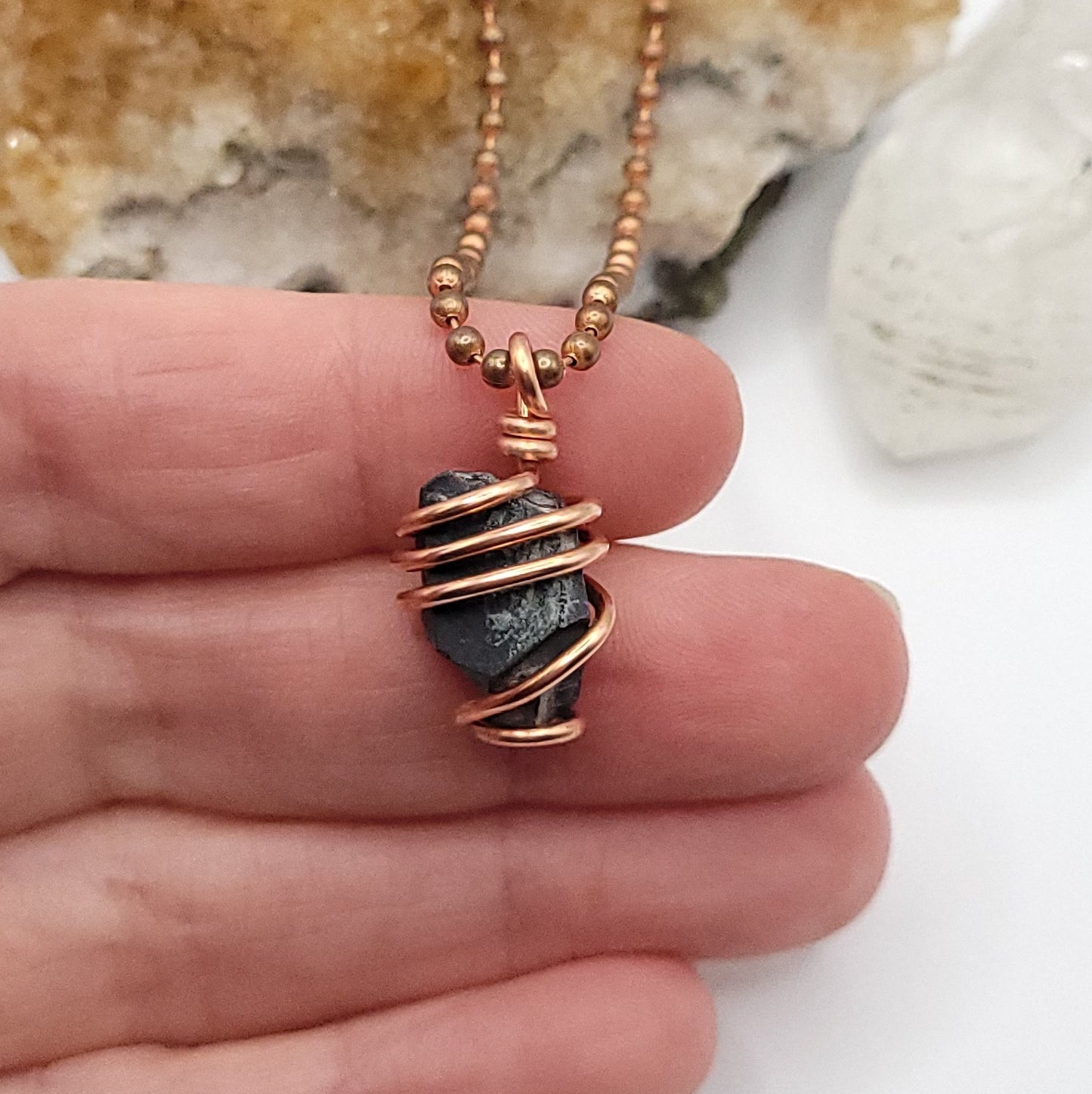 Raw Magnetite Crystal Necklace in Copper in hand