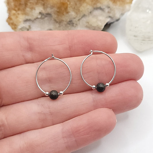 silver and pyrite hoop earrings in hand