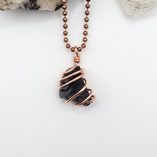 black obsidian necklace in copper on white background