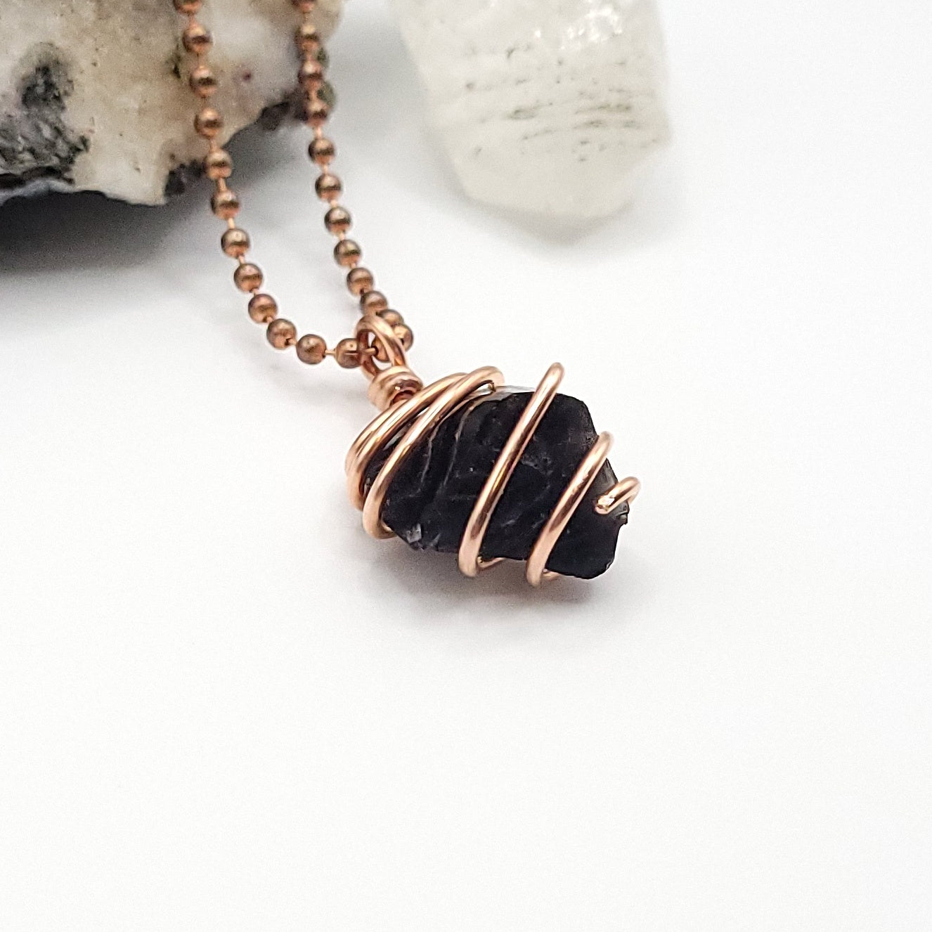 black obsidian necklace in copper on white background side view