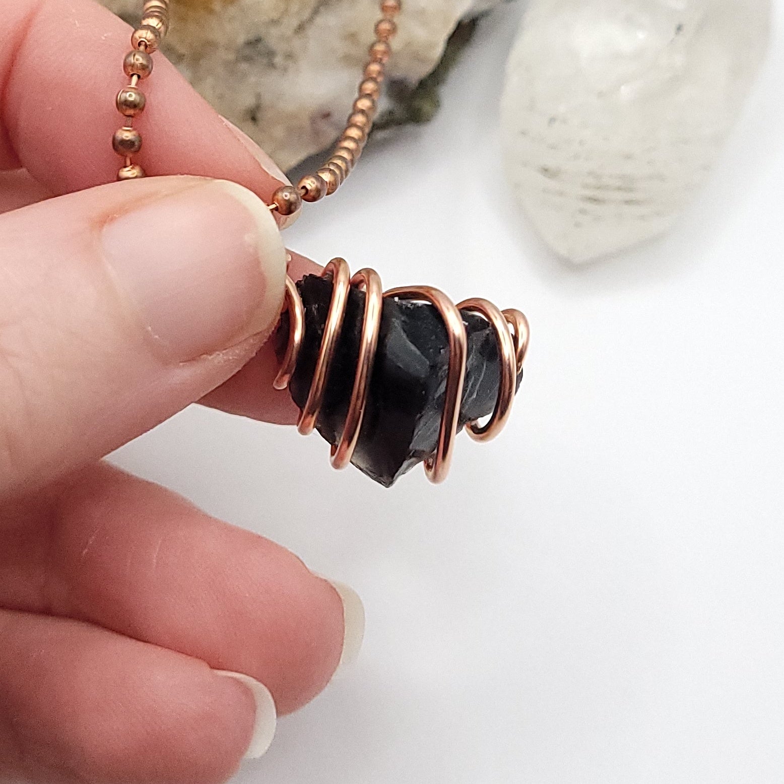 black obsidian necklace in copper on white background side view