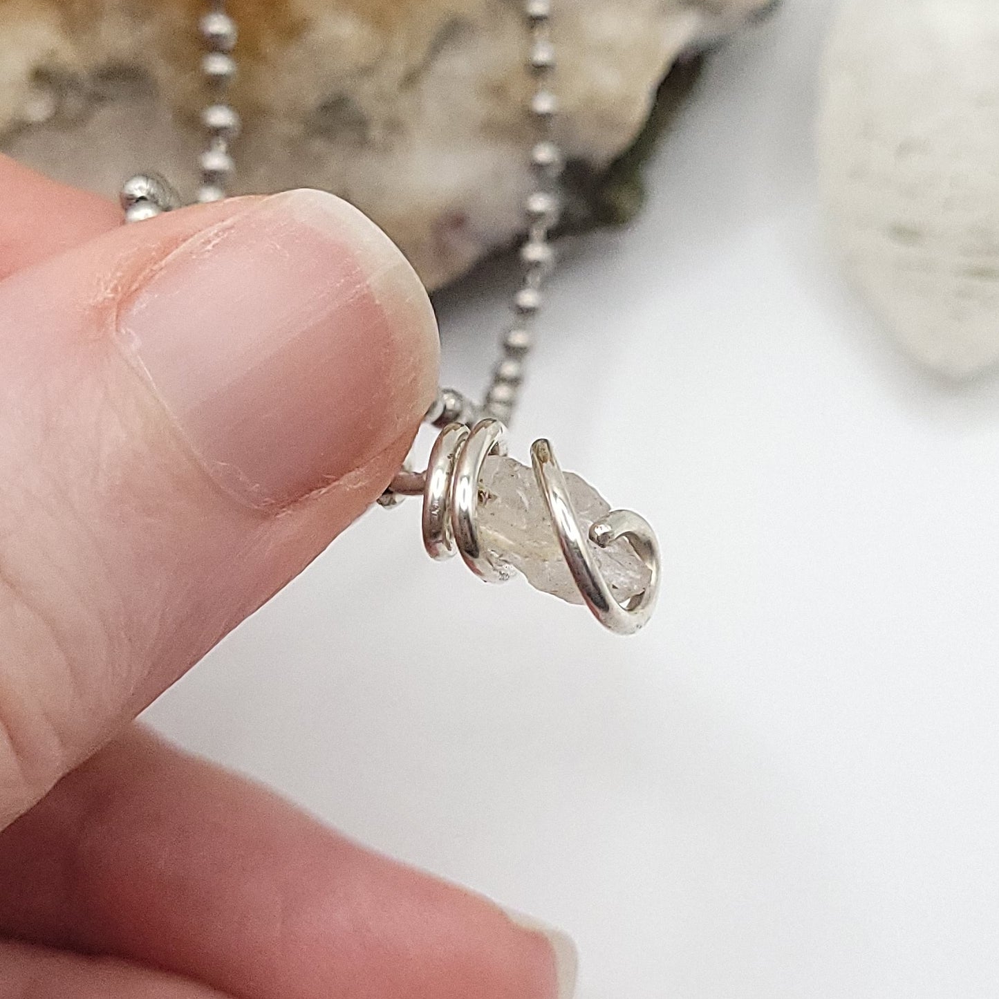 phenakite pendant side view against white background