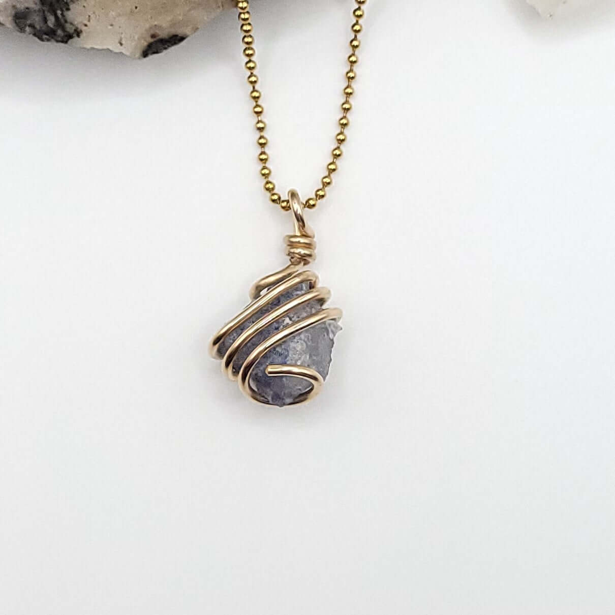 raw Dumortierite necklace in Gold white background