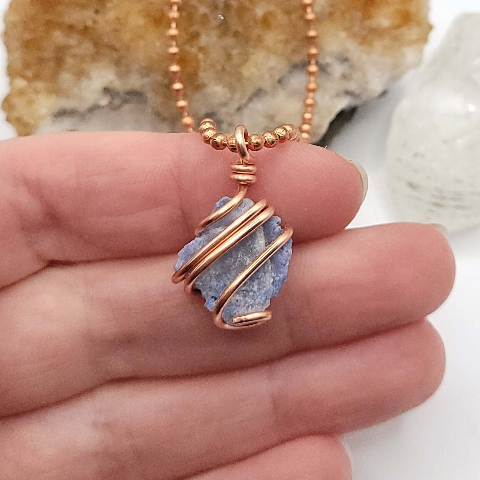 Dumortierite Quartz Crystal Pendant in Copper in hand