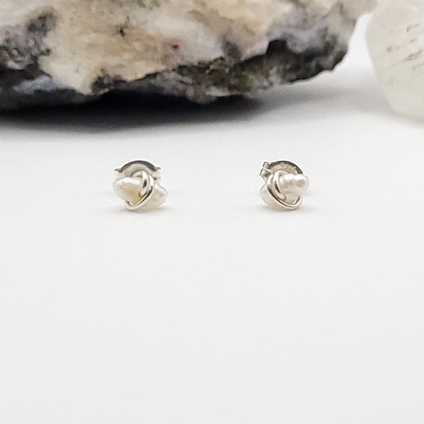 sterling silver pearl earrings on a white background