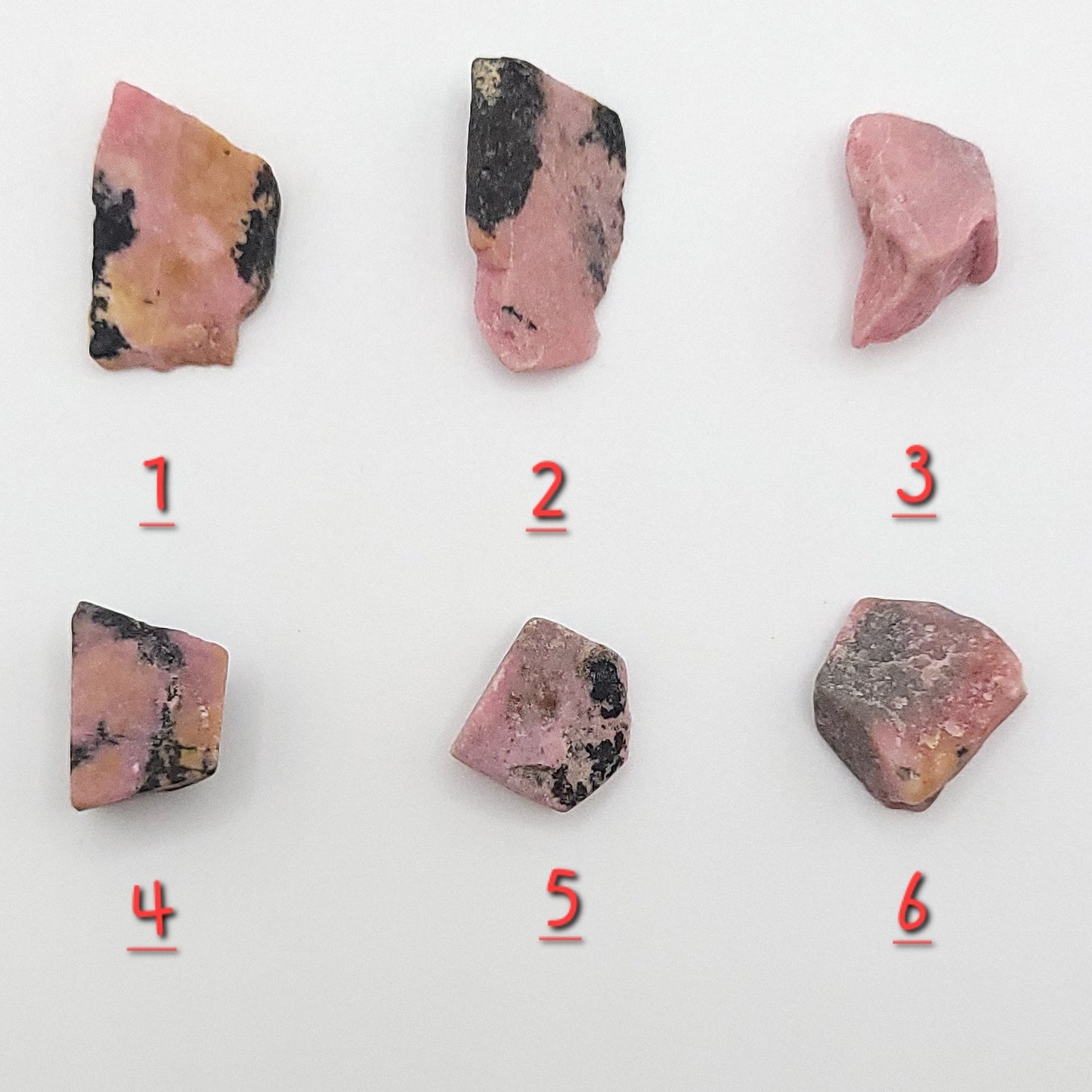 choice of 6 rhodonite pieces to choose from on white background