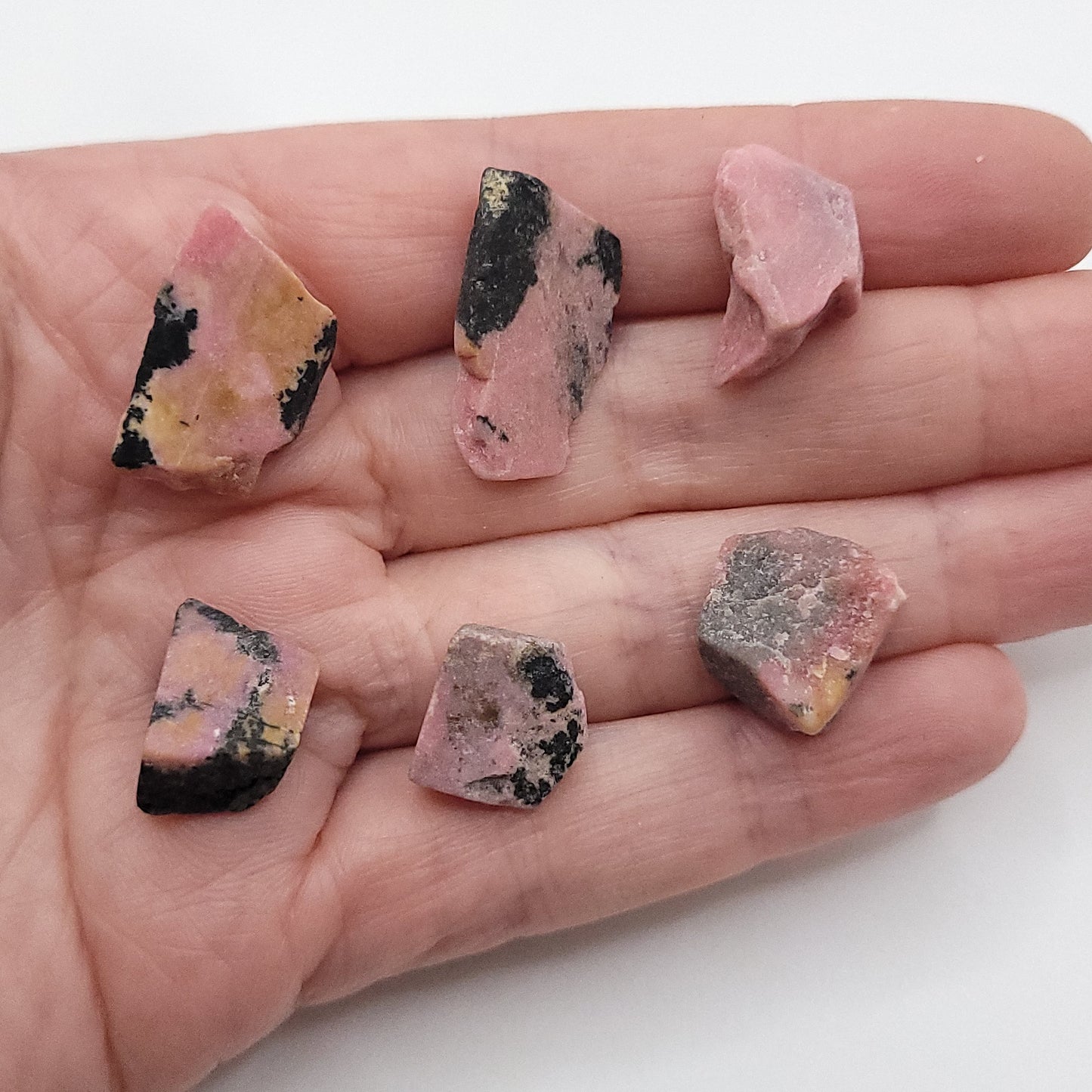 choice of 6 rhodonite pieces to choose from in hand