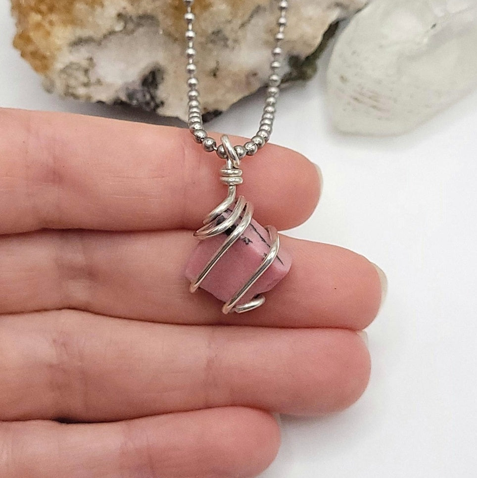 rhodonite necklace in silver in hand